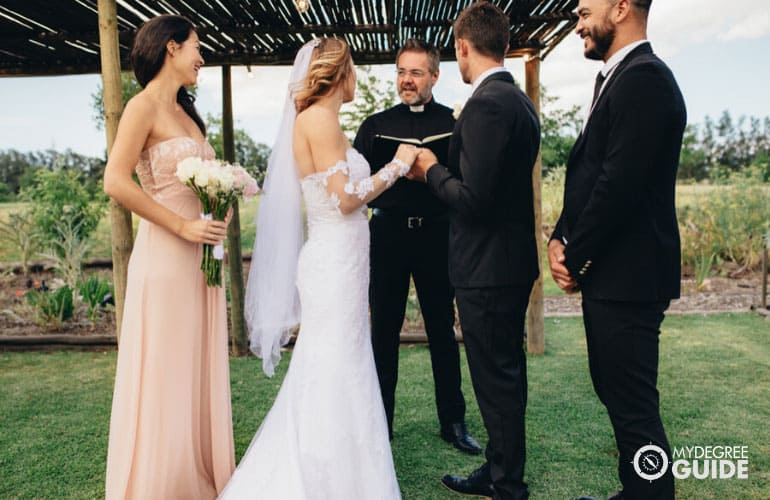 professional minister leading the marriage ceremony of a couple