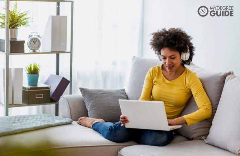 counseling degree student studying on her laptop comfortably