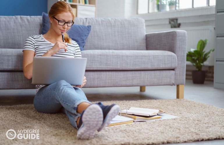 criminal justice degree student studying on her computer at home