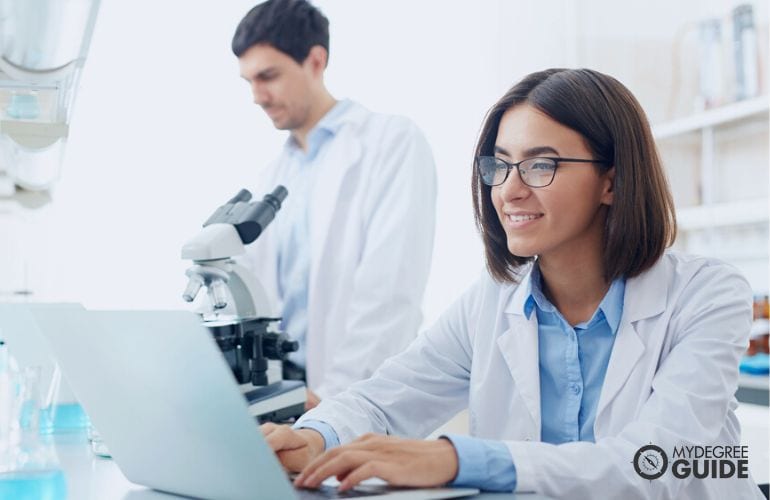 lab technician taking notes on her laptop