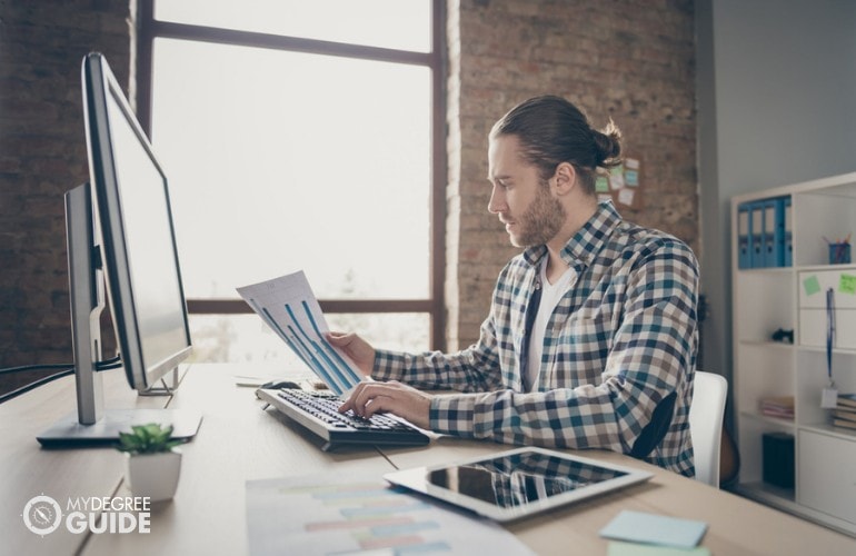 Financial Analyst working in his office