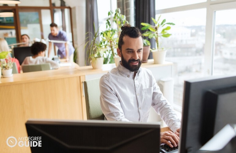 computer programmer working on his computers