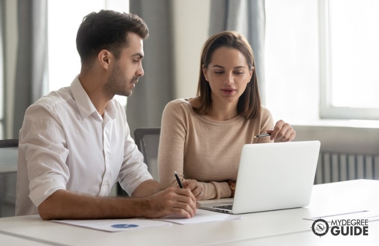 Business Consultant talking to a colleague in the office