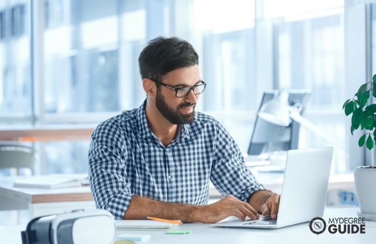 brand manager working on his laptop