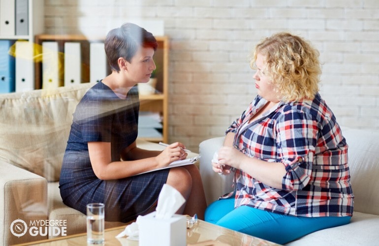 psychologist comforting her patient during therapy