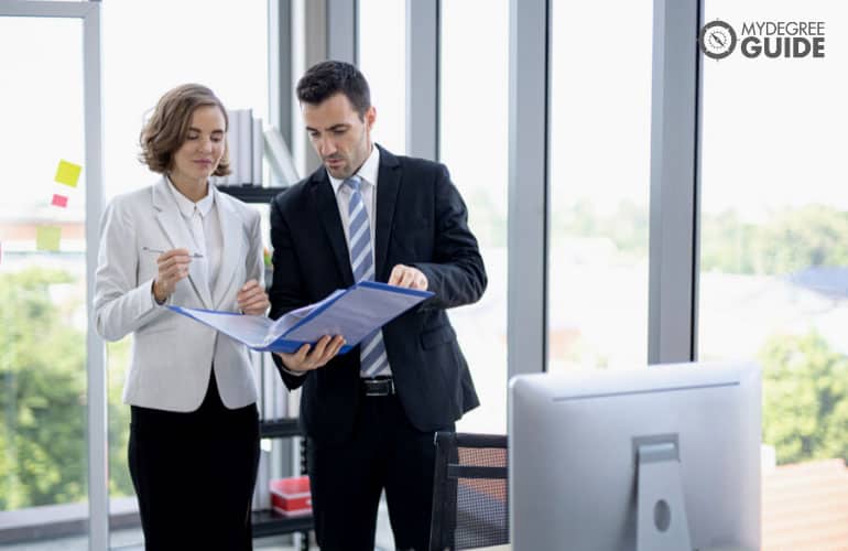 business professionals discussing near a computer