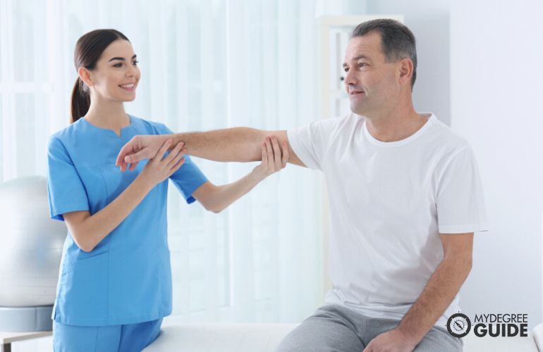 Occupational Therapist doing arm stretch exercises with a patient