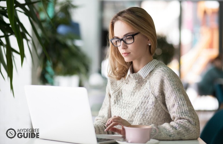 female journalist working on her computer in a cafe